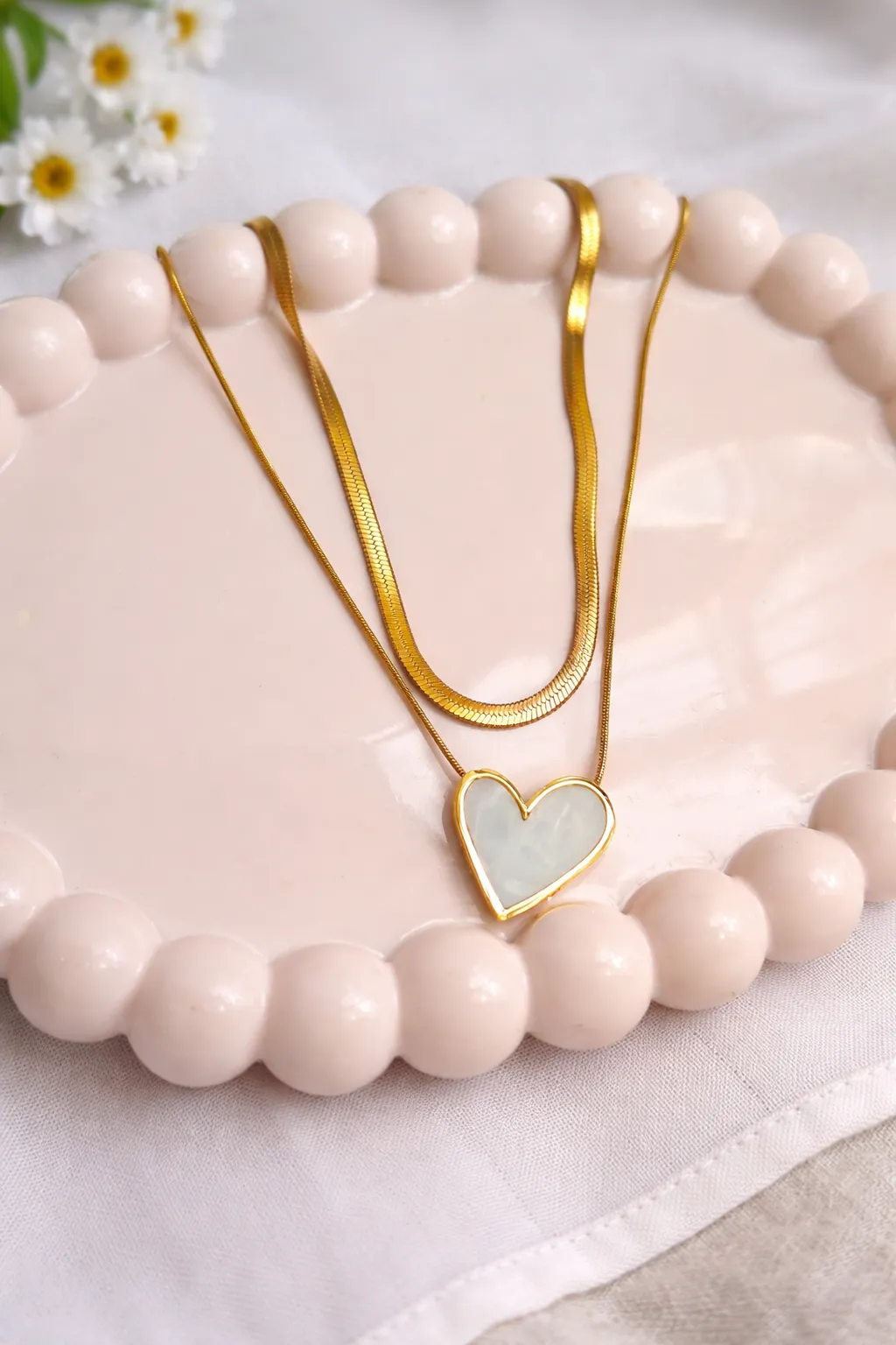 Gold bracelets stacked on wrist